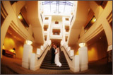 photo of a bride and groom kissing on stairs