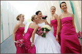 photo of four bridesmaids in pink surrounding a bride